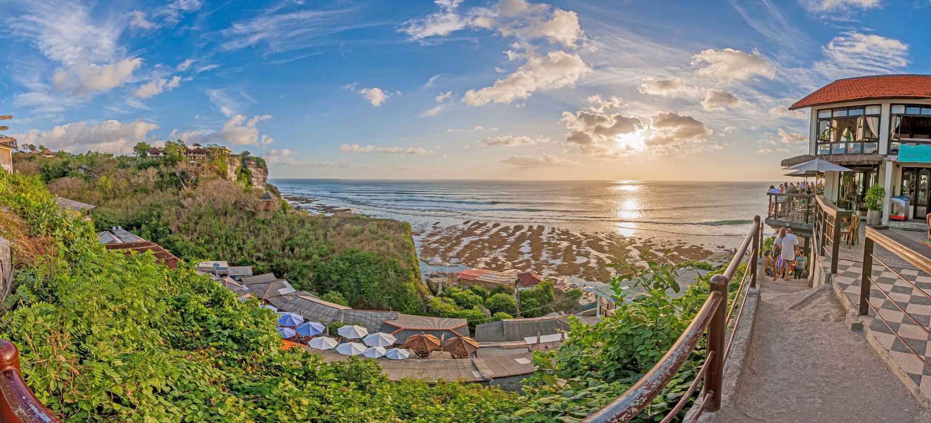 Sunset over the Bali coast from a clifftop bar terrace