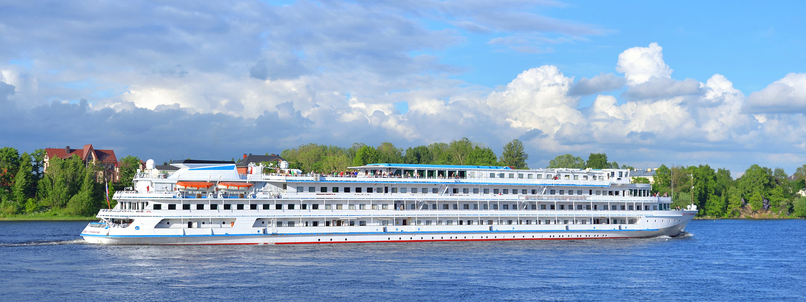 A river cruise vessel moored beside a European town