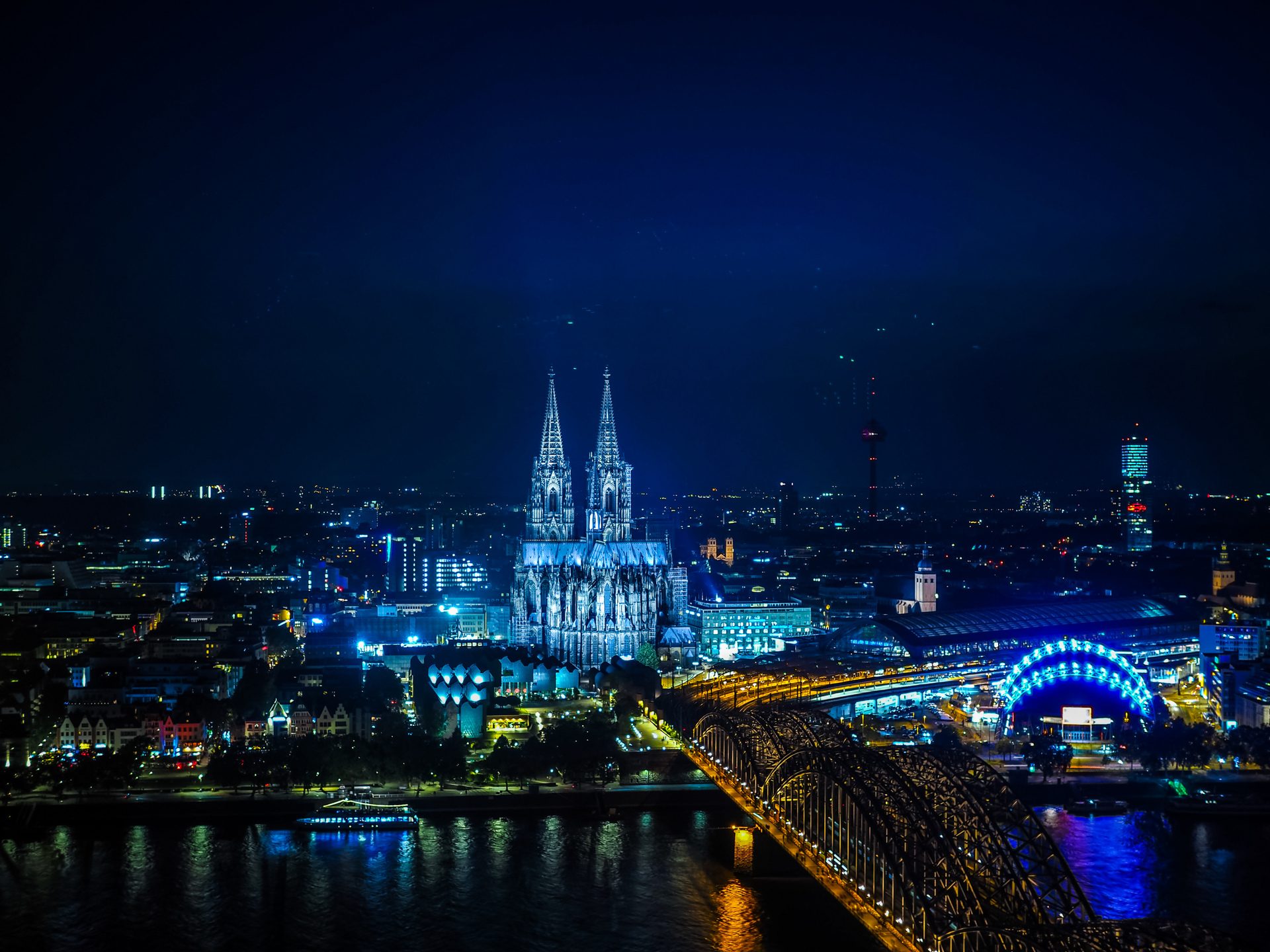 Cologne Cathedral and the Hohenzollern Bridge over the Rhine at night