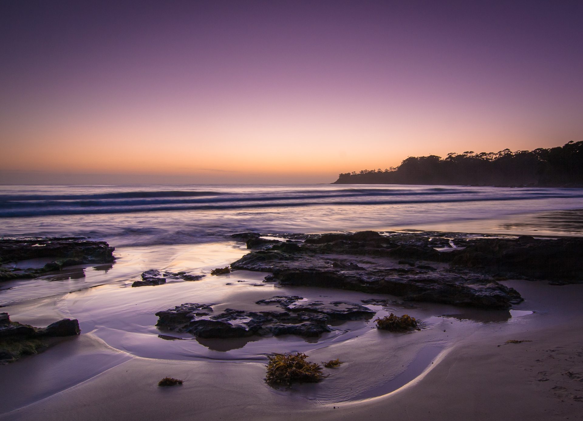 Dusk falling over a quiet stretch of coastline