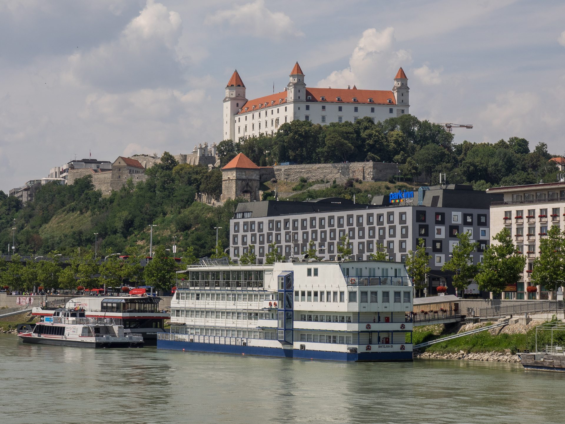 Bratislava Castle above river ships moored on the Danube